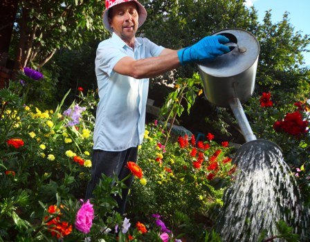 Technician controlling a high-pressure washer in action on a brick surface